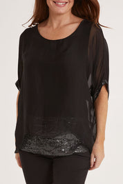 Model Sally wearing the Silk Sequin Top in colour Black (Black), from the front, cropped image