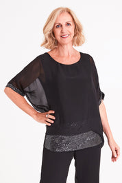 Model Sandy wearing the Silk Sequin Top in colour Black (Black), from the front, cropped image
