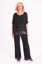 Model Sandy wearing the Silk Sequin Top in colour Black (Black), from the front, showing the whole outfit