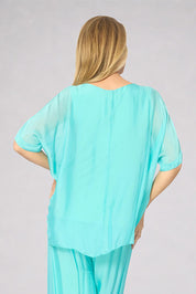 Model Genericm wearing size sample of the Silk Blend Three Layer Raw Edge Top - Acqua in colour Acqua, from the back