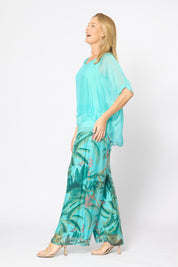Model Genericm wearing size sample of the Silk Blend Three Layer Raw Edge Top - Acqua in colour Acqua, from the front