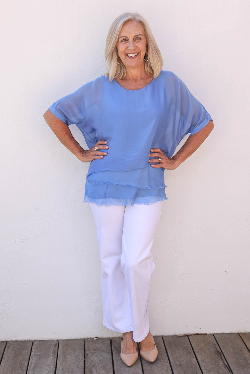 Model Sandy wearing the Silk Blend Three Layer Raw Edge Top in colour Blueturco (Blue), from the front, showing the whole outfit