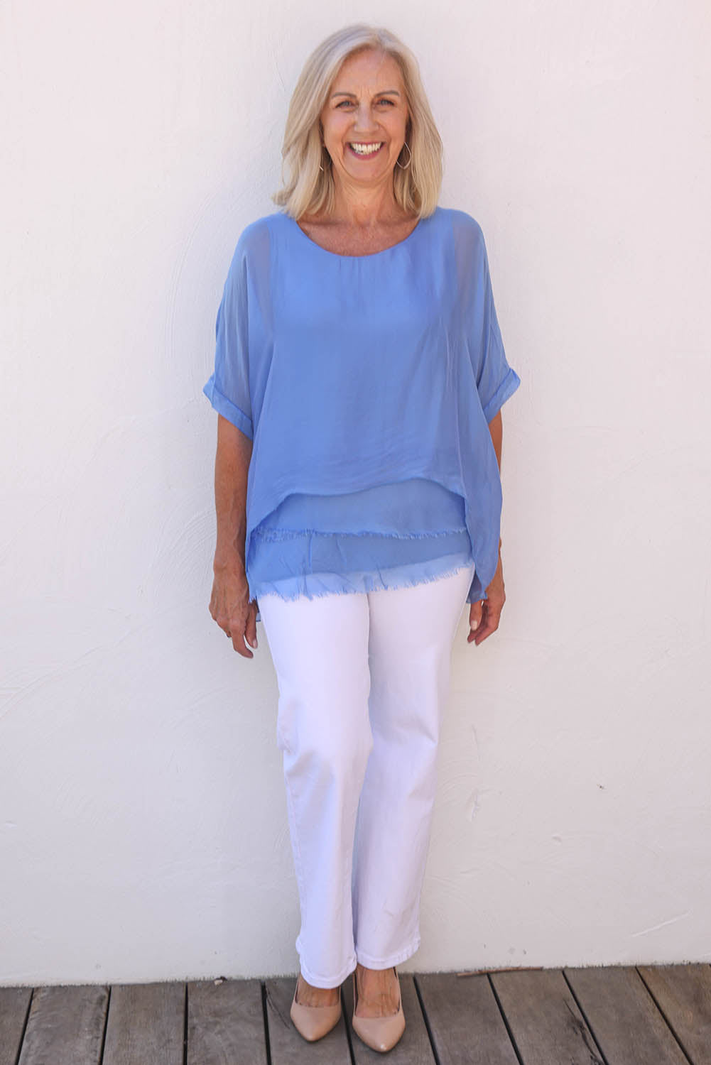 Model Sandy wearing the Silk Blend Three Layer Raw Edge Top in colour Blueturco (Blue), from the front, showing the whole outfit