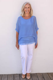 Model Sandy wearing the Silk Blend Three Layer Raw Edge Top in colour Blueturco (Blue), from the front, showing the whole outfit