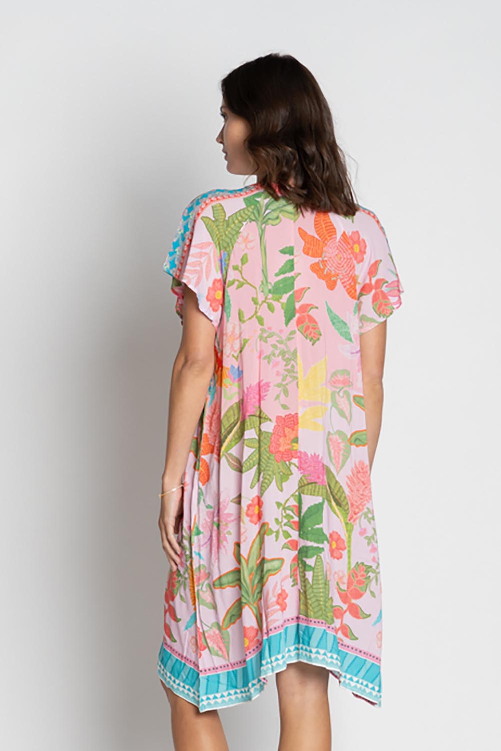 A model wearing the Anassa Dress in colour Orchidpi, from the back