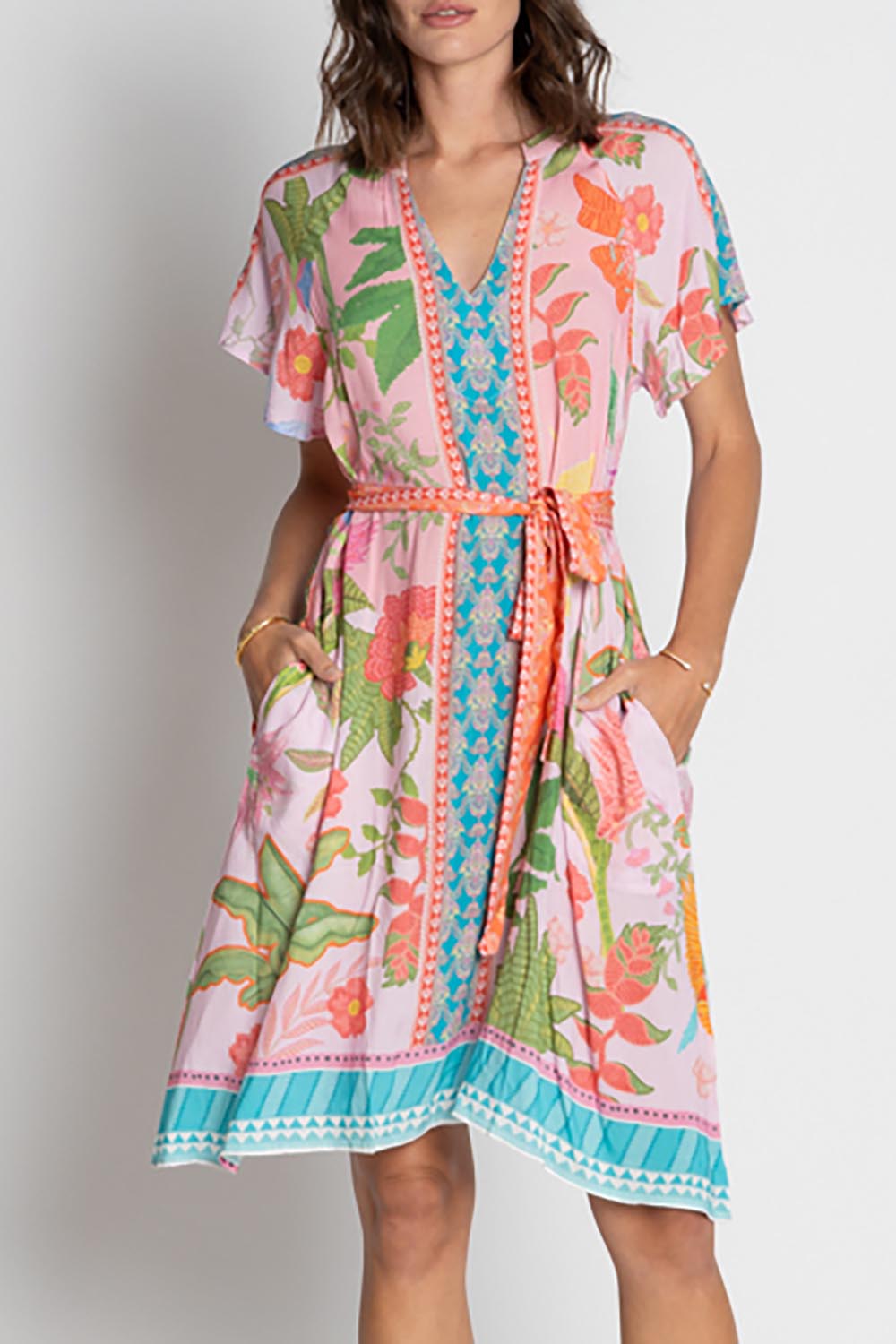 A model wearing the Anassa Dress in colour Orchidpi, from the front, cropped image