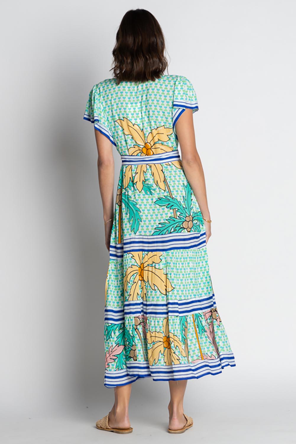 A model wearing the Aquila Maxi Dress in colour Mist (Green), from the back