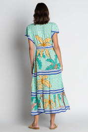 A model wearing the Aquila Maxi Dress in colour Mist (Green), from the back