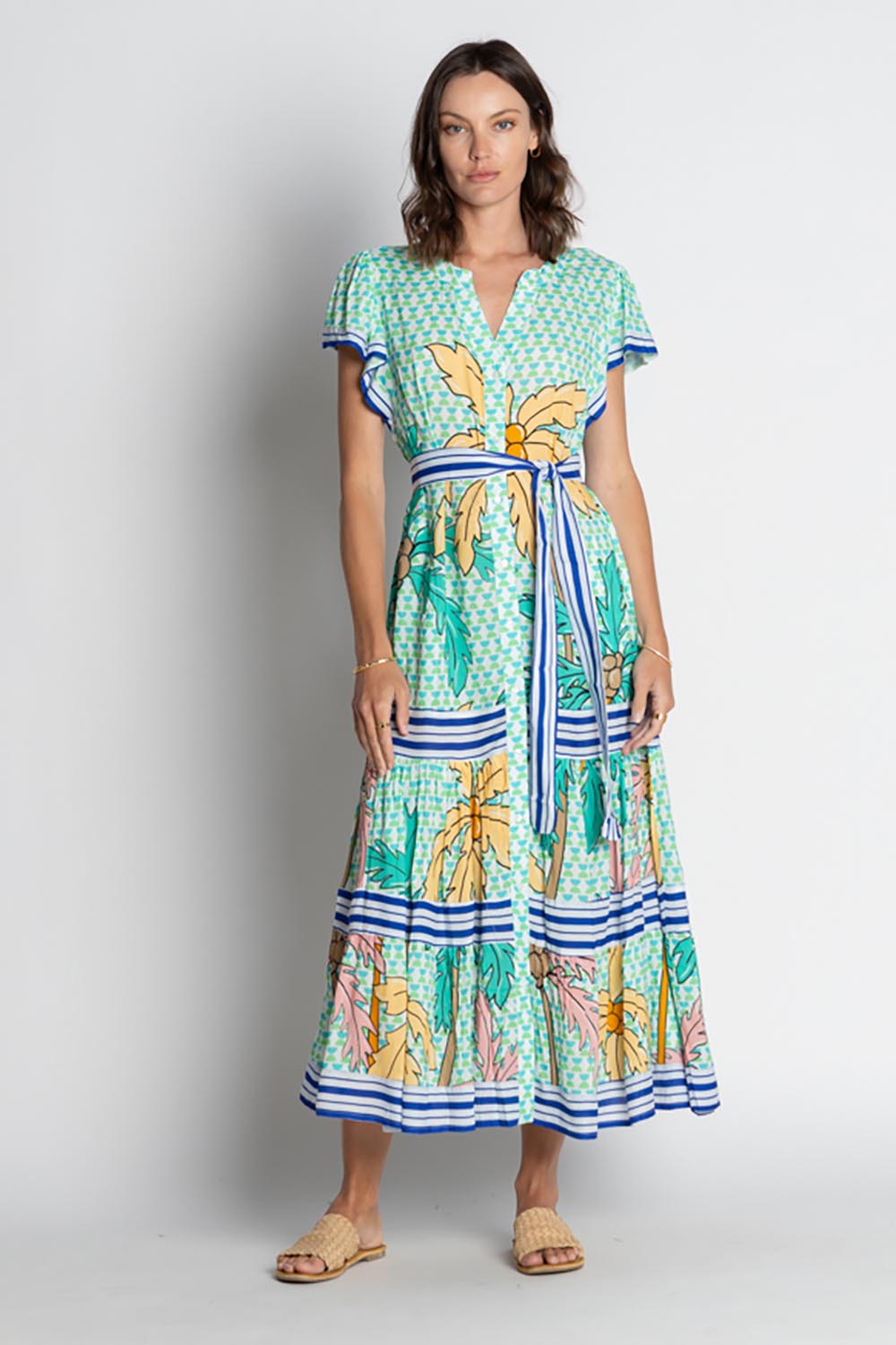 A model wearing the Aquila Maxi Dress in colour Mist (Green), from the front, showing the whole outfit