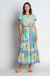 A model wearing the Aquila Maxi Dress in colour Mist (Green), from the front, showing the whole outfit