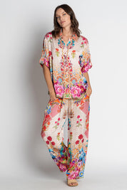 A model wearing the Baglioni Pant in colour Print, from the front, showing the whole outfit