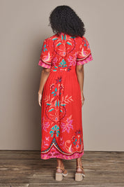 Model Ziara wearing size S of the Bahia Midi Dress in colour Geranium, from the back