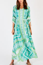 A model wearing the Bandana Cotton Maxi Dress in colour Sea (Green), from the front, cropped image