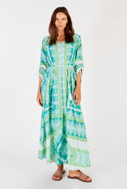 A model wearing the Bandana Cotton Maxi Dress in colour Sea (Green), from the front, showing the whole outfit