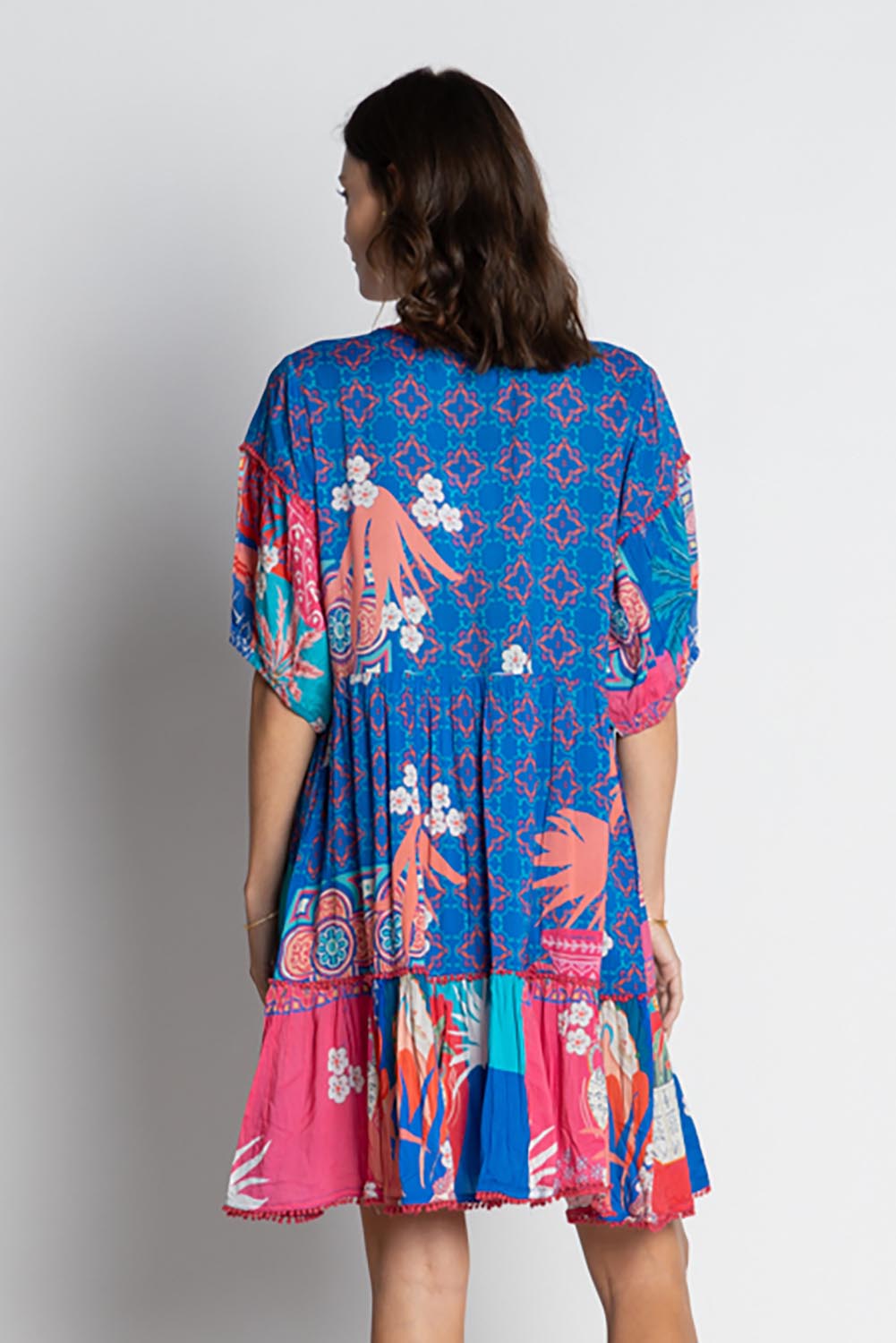 A model wearing the Busena Dress in colour Ocean, from the back