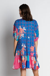 A model wearing the Busena Dress in colour Ocean, from the back