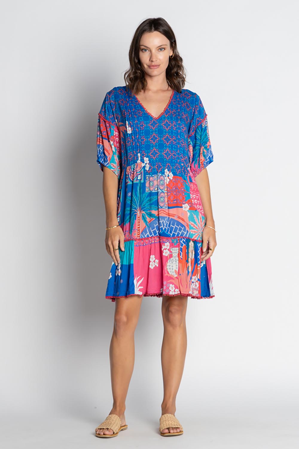 A model wearing the Busena Dress in colour Ocean, from the front, showing the whole outfit