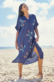 Model Eshan wearing size 10 of the Casita Kaftan Dress – Navy in colour Navy, from the front