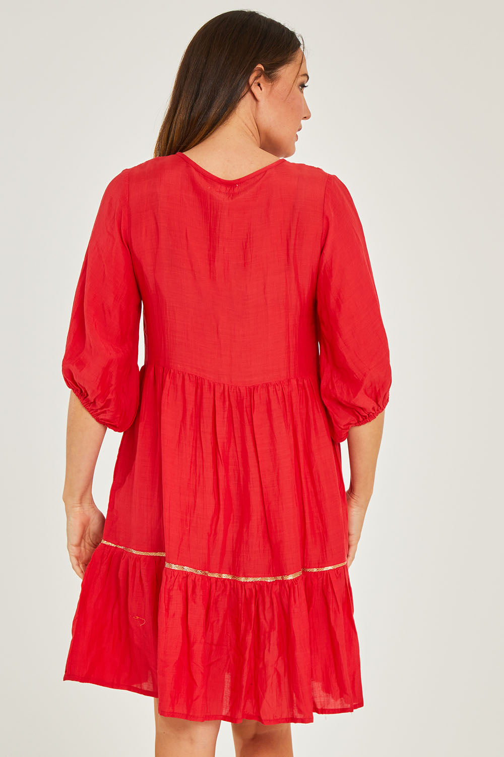 Model Georgia wearing size S of the Delilah Dress in colour Melon (Pink), from the back