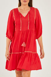 Model Georgia wearing size S of the Delilah Dress in colour Melon (Pink), from the front, cropped image