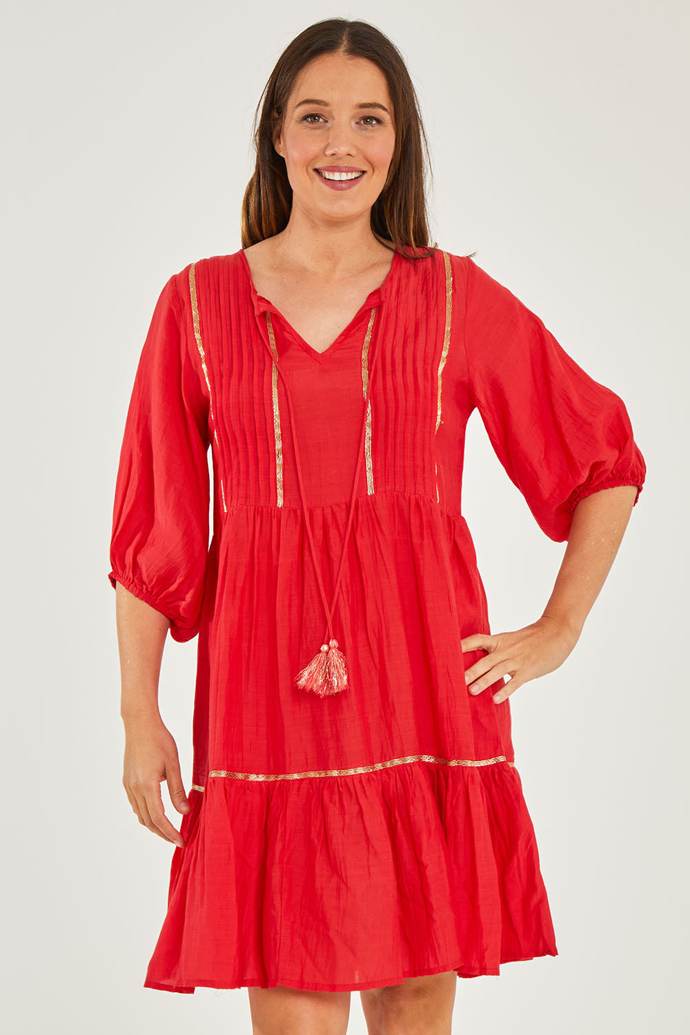 Model Georgia wearing size S of the Delilah Dress in colour Melon (Pink), from the front, cropped image
