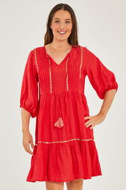 Model Georgia wearing size S of the Delilah Dress in colour Melon (Pink), from the front, cropped image
