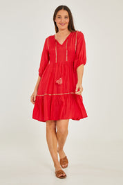 Model Georgia wearing size S of the Delilah Dress in colour Melon (Pink), from the front, showing the whole outfit