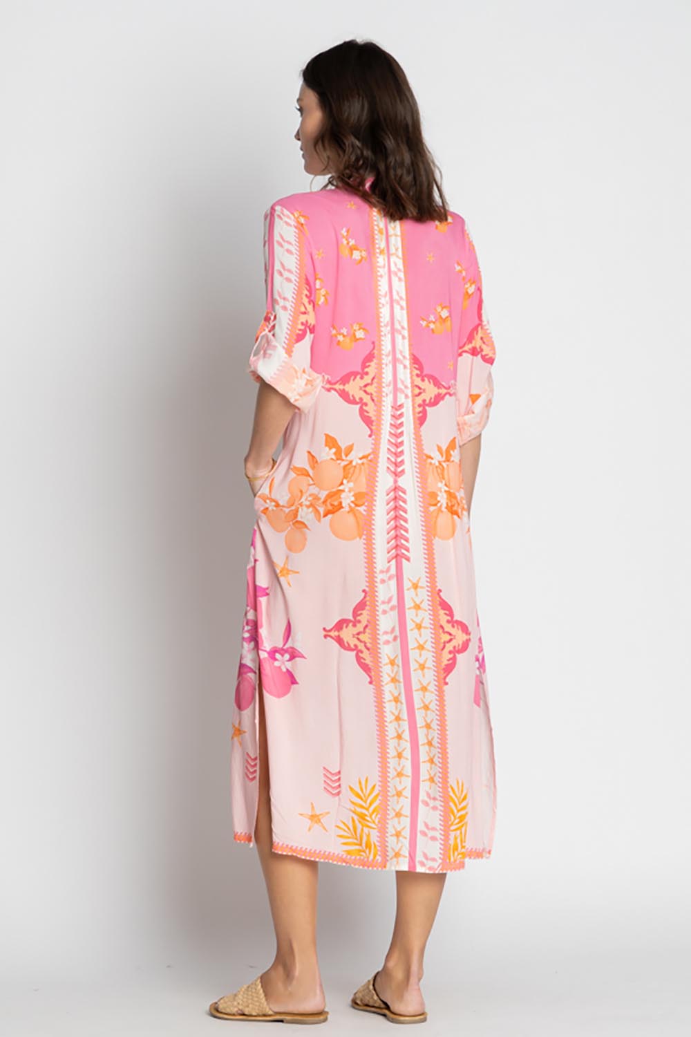 A model wearing the Espacio Midi Dress in colour Candy, from the back