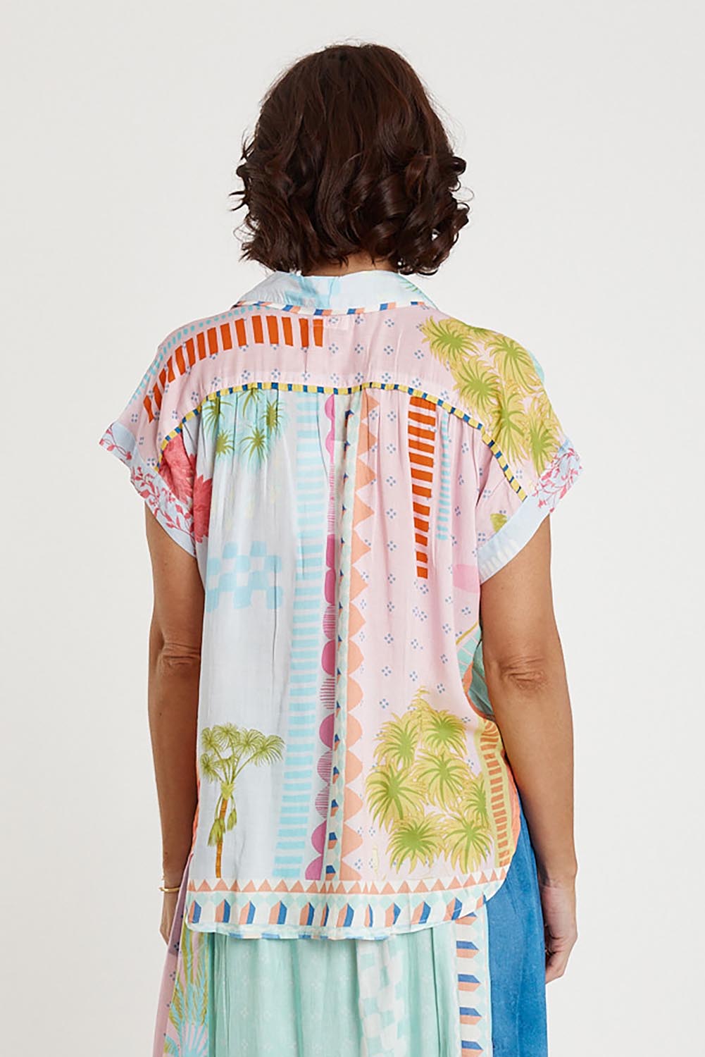 A model wearing the Etereo Top in colour Lagoon (Blue), from the back