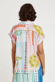 A model wearing the Etereo Top in colour Lagoon (Blue), from the back