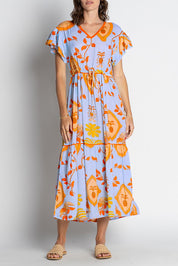 A model wearing the Juno Midi in colour Sky, from the front, cropped image