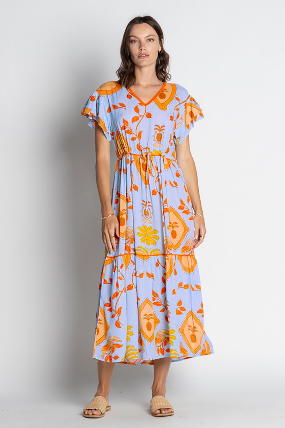 A model wearing the Juno Midi in colour Sky, from the front, showing the whole outfit