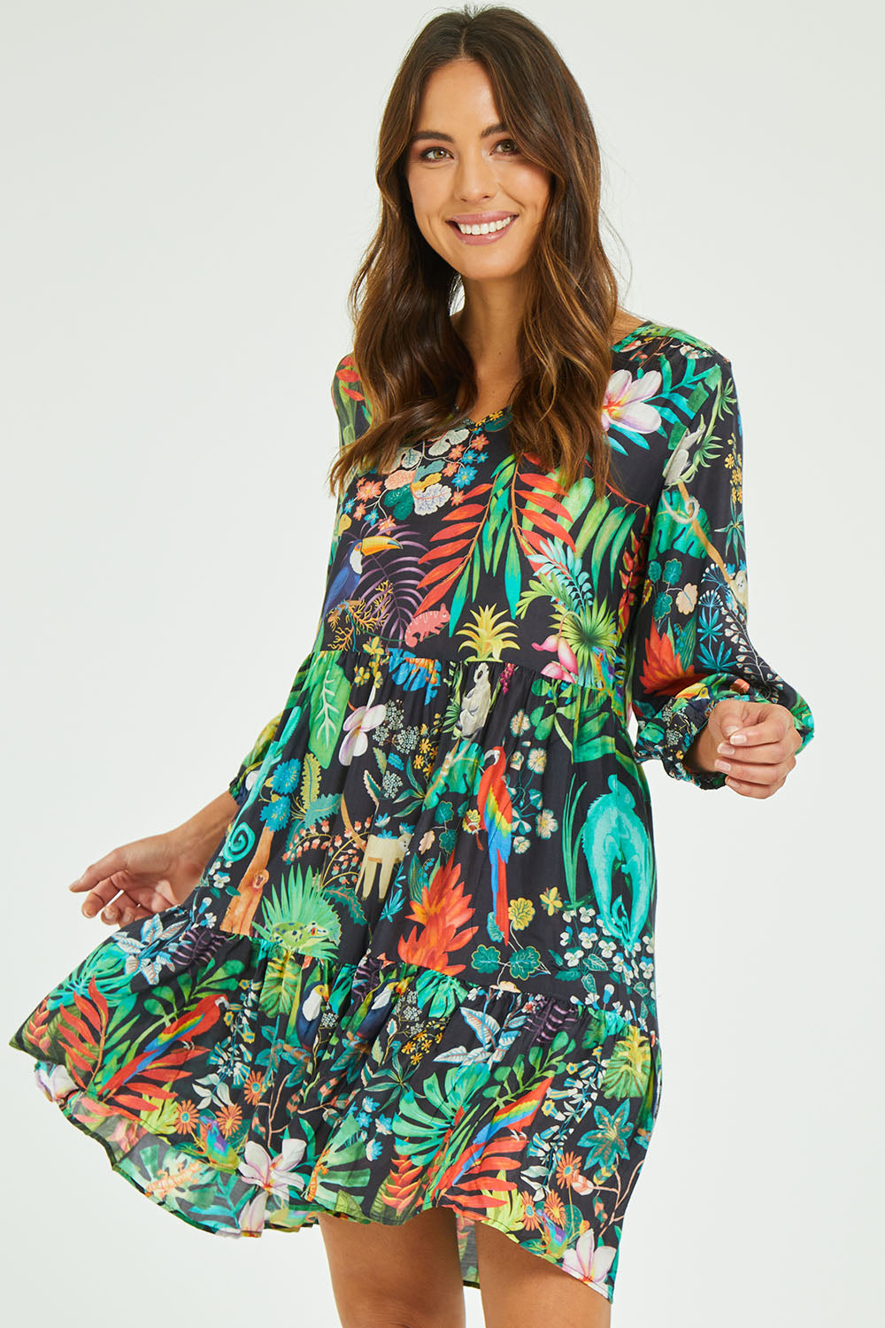 Model Madeline wearing size S of the Lucile Tiered Dress in colour Midnight (Black), from the front, cropped image