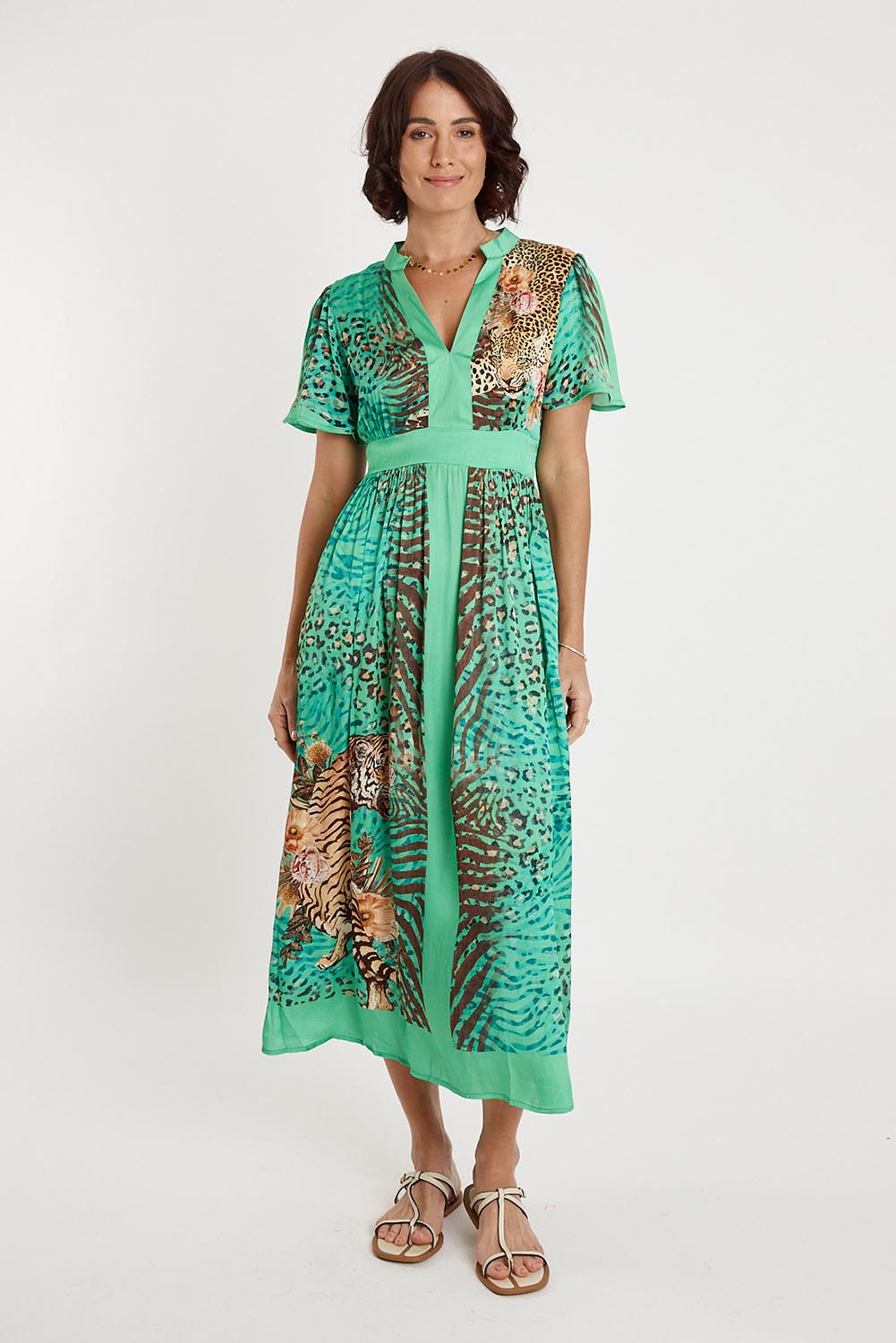 A model wearing the Maasai Midi Dress in colour Emerald (Green), from the front, showing the whole outfit