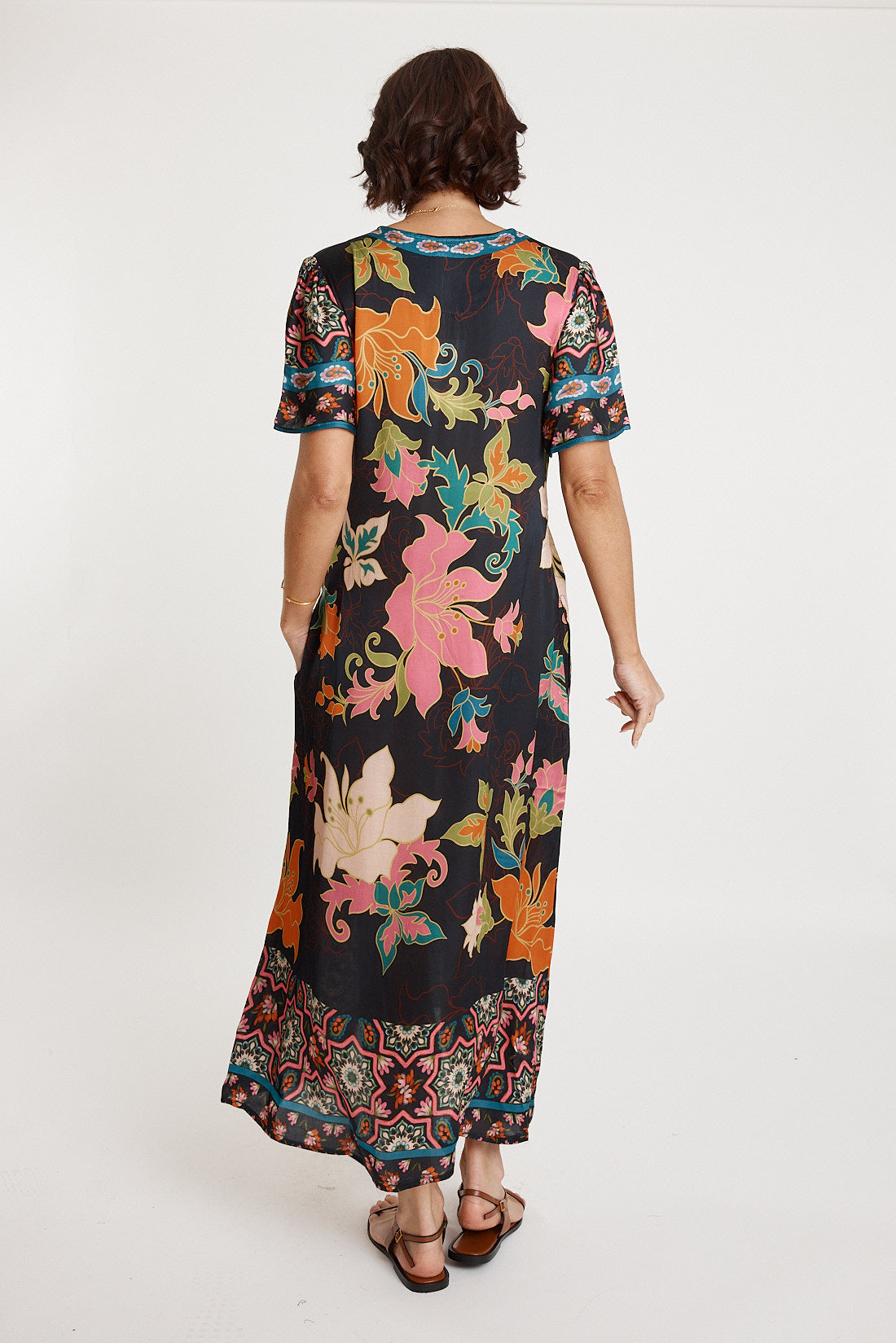 A model wearing the Marquis Modal Blend Midi Dress in colour Black (Black), from the back