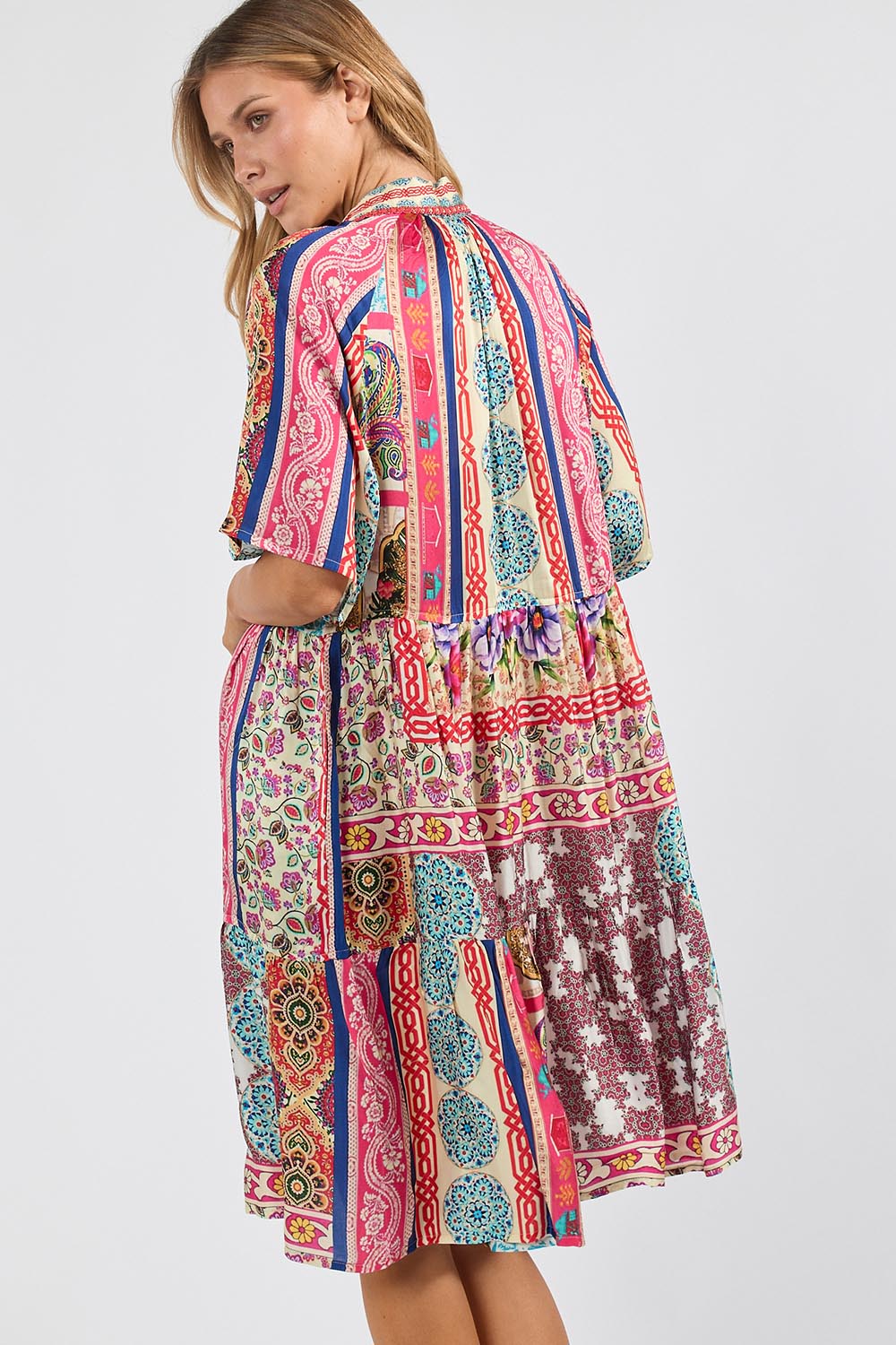 Model Genericm wearing size sample of the Miramar Dress – Print in colour Print, from an angle