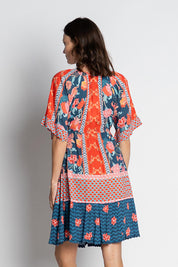 A model wearing the Mulini Dress in colour Navy, from the back
