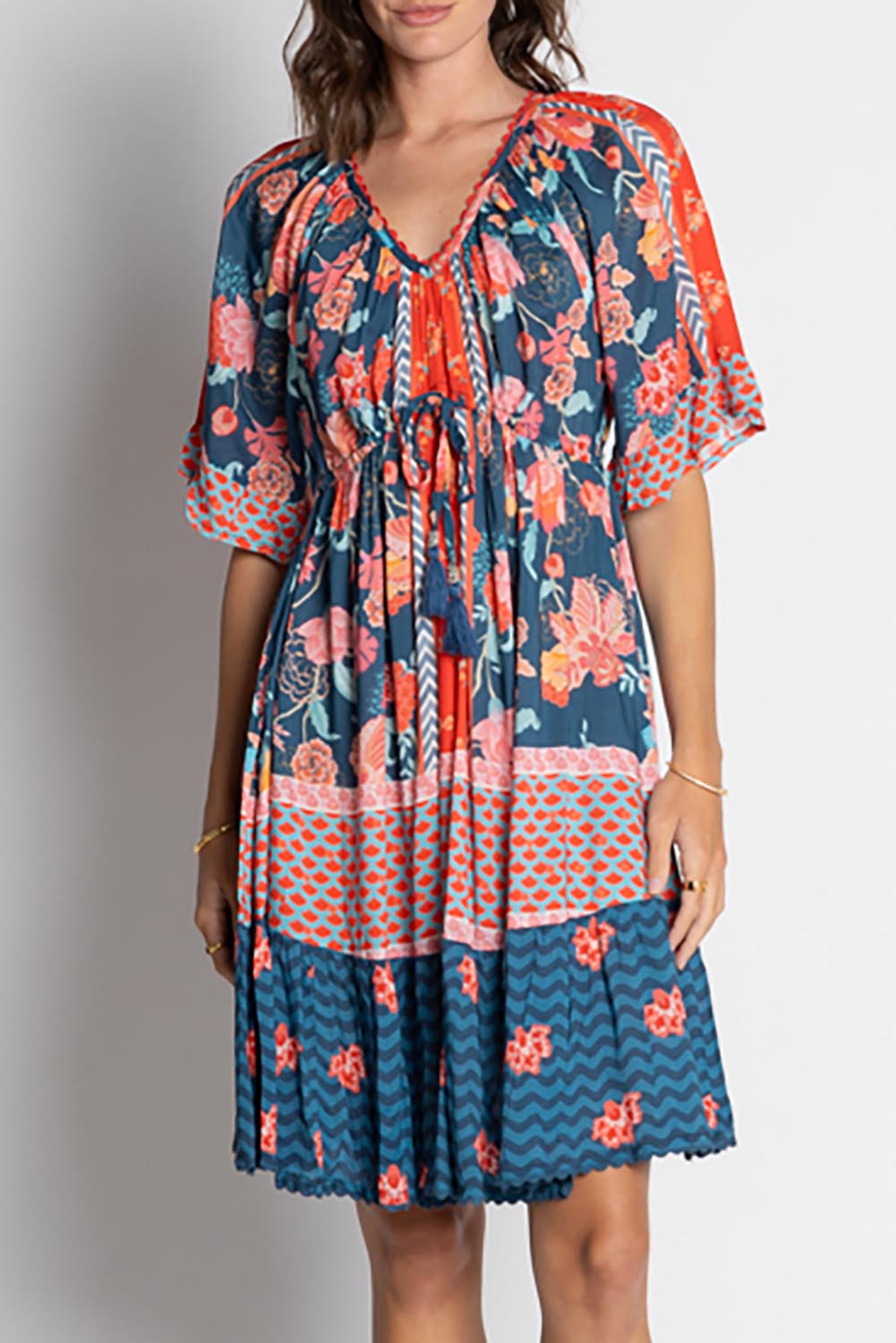 A model wearing the Mulini Dress in colour Navy, from the front, cropped image
