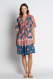 A model wearing the Mulini Dress in colour Navy, from the front, showing the whole outfit