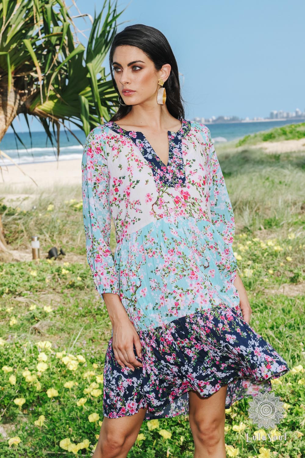 A model wearing the Myoshi Dress in colour Multi (Blue), from the front, showing the whole outfit