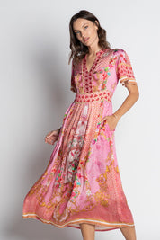 A model wearing the Pellicano Midi in colour Orchid (Pink), from the front, cropped image