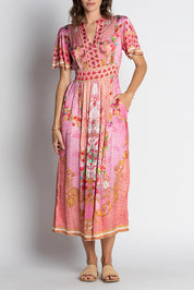 A model wearing the Pellicano Midi in colour Orchid (Pink), from the front, cropped image