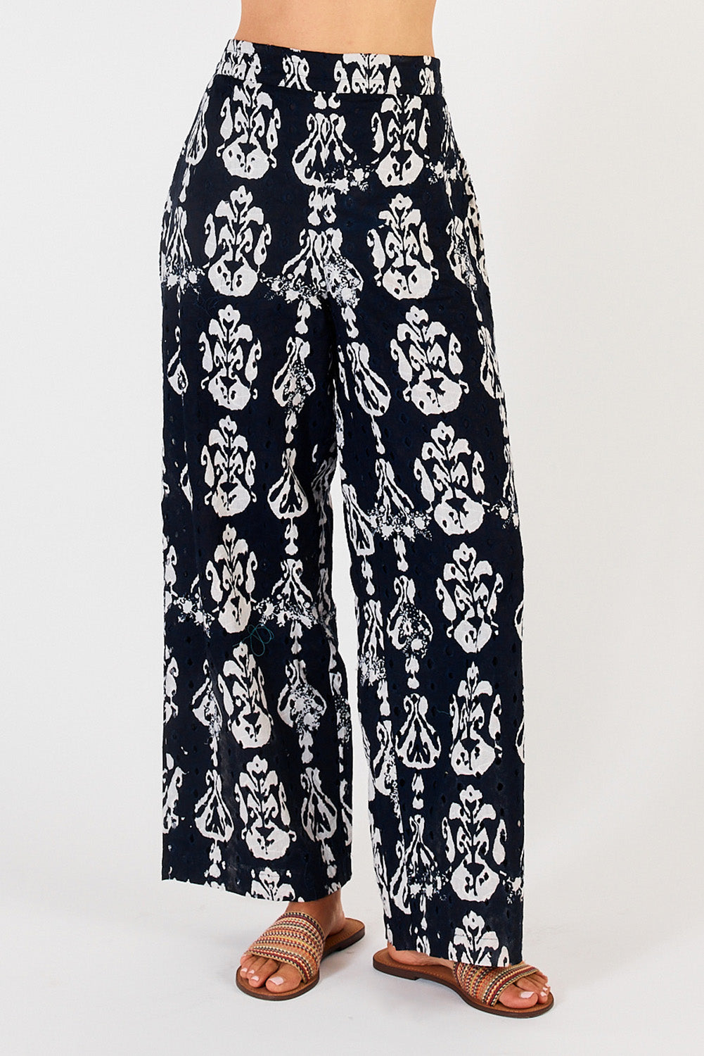 A model wearing the Verona Cotton Broderie Pant in colour Navy (Blue), from the front, cropped image