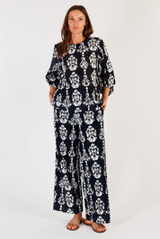 A model wearing the Verona Cotton Broderie Pant in colour Navy (Blue), from the front, showing the whole outfit