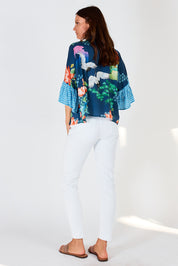 A model wearing the Yoshiko Bolero Jacket in colour Blue (Blue), from the back