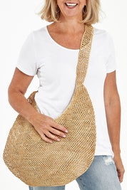 Model Sandy wearing size OneSize of the Mamy Bag in colour Natural, from the front, cropped image