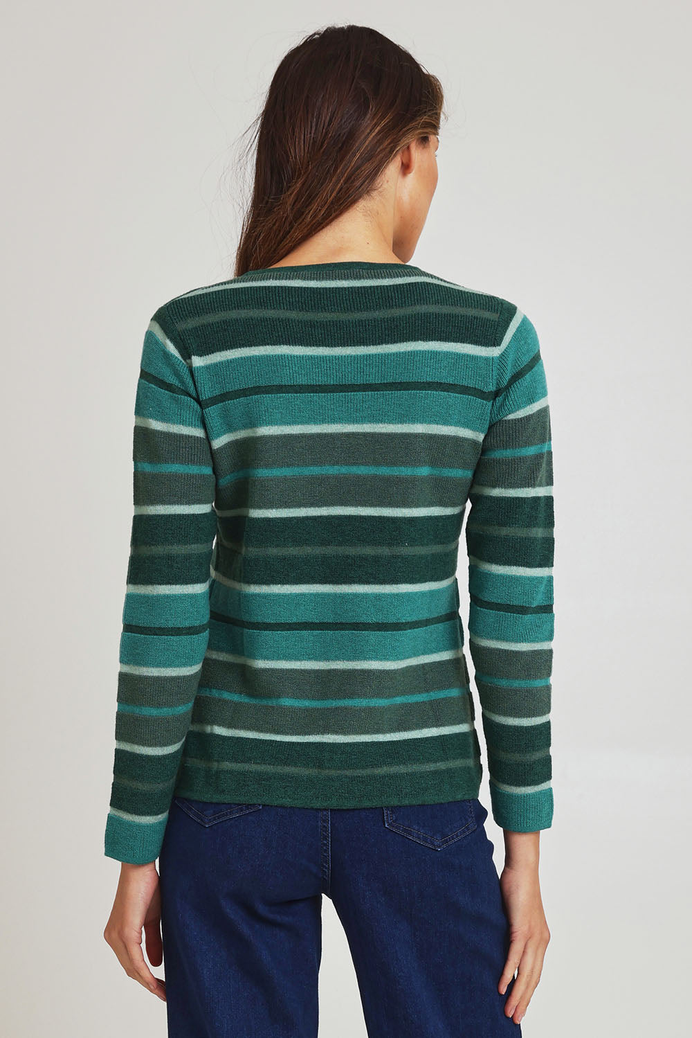 Model Madeline wearing size S of the Chloe Merino Cotton Sweater in colour Emerald (Green), from the back