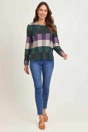 Model Madeline wearing size S of the Lillith Organic Cotton Sweater in colour Coldgreen (Green), from the front, showing the whole outfit