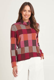Model Madeline wearing size S of the Lindi Organic Cotton Sweater in colour Spice (Pink), from the front, cropped image