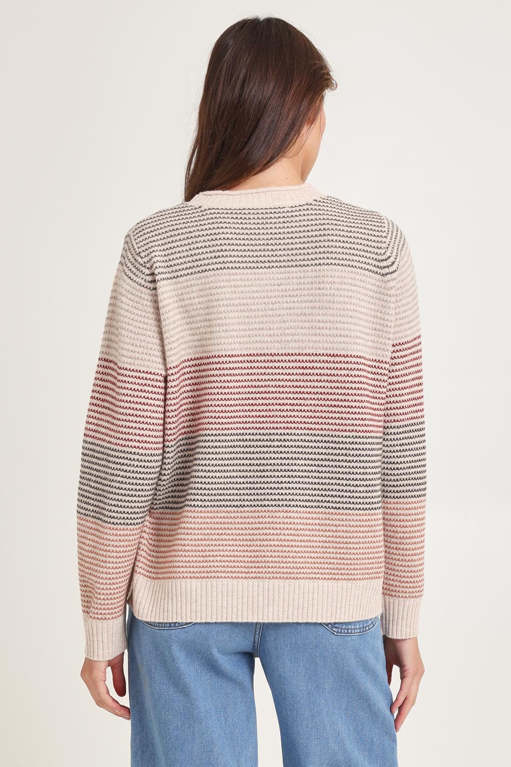 Model Madeline wearing size S of the Louise Lambswool Sweater in colour Oat, from the back